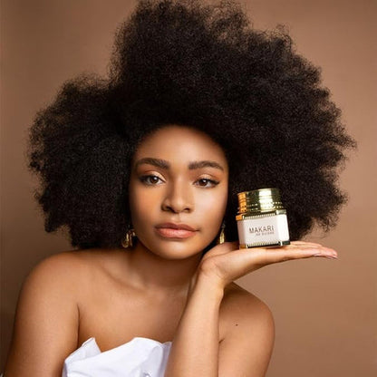 Woman holding a jar Makari De Suisse Night Radiance Treatment Cream with a brown background