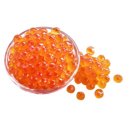 Clear glass bowl filled with orange caviar on a white background