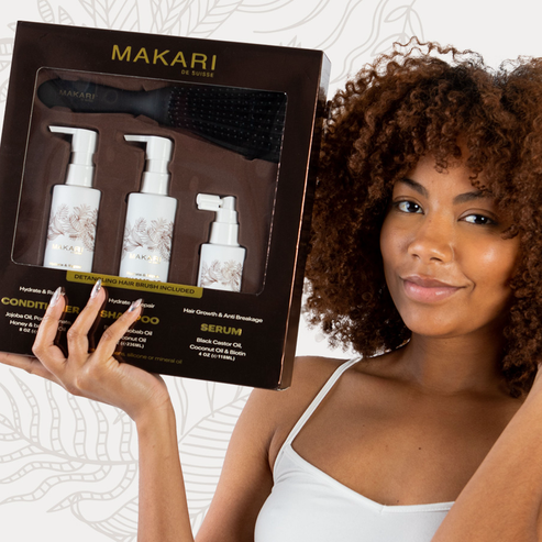 Woman holding Makari Hydrate & Repair Haircare Set with a neutral background