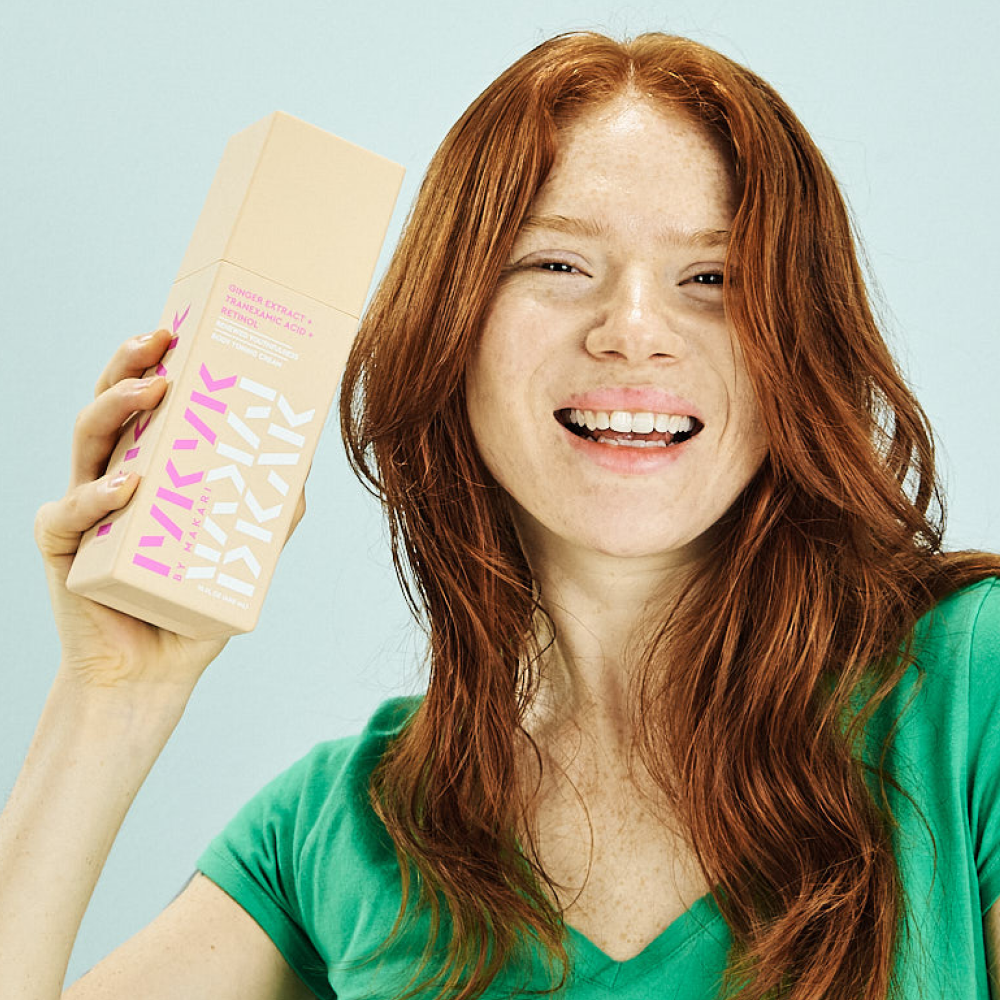 Makari IYKYK Ginger Extract + Tranexamic Acid + Retinol Body Toning Cream against a light blue background